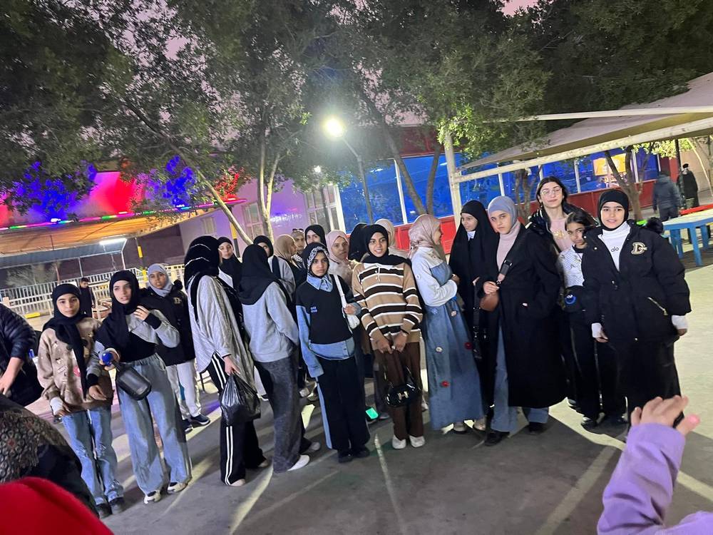 Girls on an evening trip to Baghdad's theme park